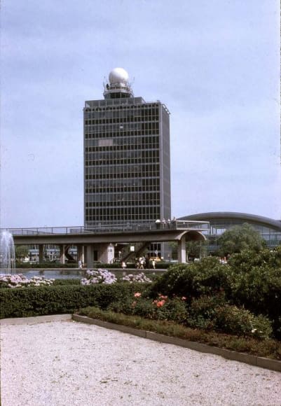Historic photo of JFK Airport control tower in 1970 with landscaped garden in foreground