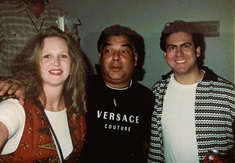 Woman and man smiling with Gipsy Kings singer Nicolas Reyes backstage after a concert, capturing a meaningful VIP travel moment.